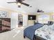 Spacious main bedroom featuring ceiling fans, a TV, and balcony at 8030 Manasota Key Rd, Englewood, FL 34223