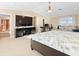 Open Primary bedroom featuring a bed, seating area, TV, and water view at 8030 Manasota Key Rd, Englewood, FL 34223