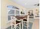 Cozy dining area bathed in natural light with a wooden table and seating for four at 8030 Manasota Key Rd, Englewood, FL 34223