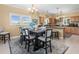 Charming dining area with a table set for eight, wood floors and windows at 8030 Manasota Key Rd, Englewood, FL 34223