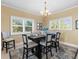 Inviting dining room featuring a table set for dinner, with ample natural light from the windows at 8030 Manasota Key Rd, Englewood, FL 34223