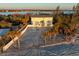 Beautiful beach house with a pool and palm trees lining the sandy backyard at 8030 Manasota Key Rd, Englewood, FL 34223