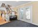 Bright foyer with decorative glass doors, adjacent staircase, and classic decor, offering a warm welcome at 8030 Manasota Key Rd, Englewood, FL 34223
