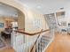 Elegant foyer with hardwood floors, staircase, and views of the kitchen and living area at 8030 Manasota Key Rd, Englewood, FL 34223