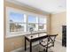 Bright home office with black desk, white shutters, and serene water view at 8030 Manasota Key Rd, Englewood, FL 34223