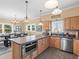 Open-concept kitchen with stainless steel appliances, a center island, and an adjacent dining area at 8030 Manasota Key Rd, Englewood, FL 34223