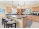Spacious kitchen with barstool seating, light wood cabinets, and updated appliances at 8030 Manasota Key Rd, Englewood, FL 34223
