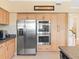 Traditional style kitchen featuring built-in double ovens and stainless refrigerator at 8030 Manasota Key Rd, Englewood, FL 34223