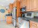 Kitchen featuring stainless steel appliances and light wooden cabinetry, providing ample storage at 8030 Manasota Key Rd, Englewood, FL 34223