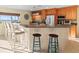 Kitchen bar with counter seating offers a casual dining spot and a peek at beach views through the window at 8030 Manasota Key Rd, Englewood, FL 34223