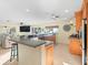 Open-concept kitchen with a sleek breakfast bar, connecting living spaces with view of the beach at 8030 Manasota Key Rd, Englewood, FL 34223