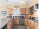 Traditional kitchen with tan cabinets, stainless appliances and coastal decor elements at 8030 Manasota Key Rd, Englewood, FL 34223