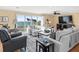 Cozy living room with plush seating, large windows offering ocean views, and stylish decor at 8030 Manasota Key Rd, Englewood, FL 34223