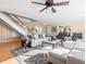 Open living area with staircase, ceiling fan, comfortable seating and bright, neutral decor at 8030 Manasota Key Rd, Englewood, FL 34223