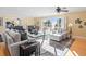Bright living room with ceiling fan, neutral furniture, and stunning views of the ocean at 8030 Manasota Key Rd, Englewood, FL 34223