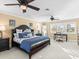 Spacious main bedroom featuring two ceiling fans, a large bed, and lots of natural light at 8030 Manasota Key Rd, Englewood, FL 34223