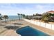 A view of the backyard pool with sandy beach and ocean in background at 8030 Manasota Key Rd, Englewood, FL 34223