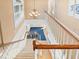 Carpeted staircase with white railings and a view of the living room at 8030 Manasota Key Rd, Englewood, FL 34223