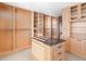 Custom walk-in closet with plenty of storage space and a granite island at 8030 Manasota Key Rd, Englewood, FL 34223