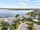 Aerial view of the lake community with well-maintained landscaping, a pool area, and waterfront views at 10742 Verawood Dr, Riverview, FL 33579