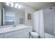 Modern bathroom features a shower, tub and white vanity with ample storage at 10742 Verawood Dr, Riverview, FL 33579