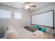 Cozy bedroom features home theater screen and plush seating area at 10742 Verawood Dr, Riverview, FL 33579