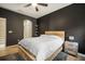 Modern bedroom features a ceiling fan, wood accent wall, and gray rug at 10742 Verawood Dr, Riverview, FL 33579