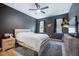Main bedroom with dark walls, modern furnishings, and hardwood flooring at 10742 Verawood Dr, Riverview, FL 33579