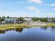 Clubhouse view of a lakefront community featuring outdoor seating, a sandy area, and lush landscaping at 10742 Verawood Dr, Riverview, FL 33579
