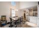 Bright dining room with vaulted ceilings, modern chandelier and seating for six at 10742 Verawood Dr, Riverview, FL 33579