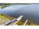 Waterfront view of dock with boat ramp leading to the lake, surrounded by lush greenery, perfect for water activities at 10742 Verawood Dr, Riverview, FL 33579