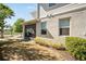 Exterior of the screened patio and yard is landscaped with mature plantings at 10742 Verawood Dr, Riverview, FL 33579
