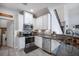 Modern kitchen features stainless steel appliances, granite countertops, and white cabinetry at 10742 Verawood Dr, Riverview, FL 33579