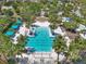 Aerial view of community pool area featuring palm trees, lounge chairs, cabanas and bright blue swimming pool at 10742 Verawood Dr, Riverview, FL 33579