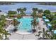 Community pool aerial view featuring inviting lounge area with chairs, tables, and lake views in the background at 10742 Verawood Dr, Riverview, FL 33579