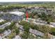 Aerial view of townhomes and the surrounding community including a shopping center at 11357 Stratton Park Dr # 11357, Temple Terrace, FL 33617