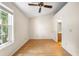 This bedroom features a window, wood floors, a fan, and neutral walls at 11357 Stratton Park Dr # 11357, Temple Terrace, FL 33617