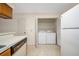 Practical kitchen with dishwasher and laundry closet with appliances at 11357 Stratton Park Dr # 11357, Temple Terrace, FL 33617