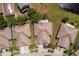 Aerial view of a neighborhood featuring well-maintained houses, green spaces, and a tranquil lake at 11466 Captiva Kay Dr, Riverview, FL 33569