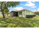 Spacious backyard with lush green grass, mature trees, a screened-in patio, and a peaceful outdoor retreat at 11466 Captiva Kay Dr, Riverview, FL 33569