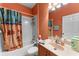 Bathroom with tub shower combo, vanity and tropical themed shower curtain at 11466 Captiva Kay Dr, Riverview, FL 33569