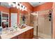 Well-lit bathroom with a vanity, mirror, and glass-enclosed shower, offering a clean and modern aesthetic at 11466 Captiva Kay Dr, Riverview, FL 33569