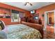 Comfortable bedroom features dark wooden furniture, overhead fan, and bright natural light at 11466 Captiva Kay Dr, Riverview, FL 33569
