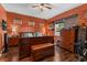 Bedroom featuring hardwood floors, a large bed, and a collection of wooden furniture providing practical storage at 11466 Captiva Kay Dr, Riverview, FL 33569