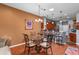 Cozy dining area adjacent to the kitchen features a glass-top table and comfortable seating with hardwood floors at 11466 Captiva Kay Dr, Riverview, FL 33569