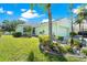 Charming light green single-story home with lush landscaping, rock garden and a well-manicured lawn at 11466 Captiva Kay Dr, Riverview, FL 33569
