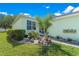 Close up view of the front entrance, with manicured shrubs, decorative rock garden, and tiled walkway at 11466 Captiva Kay Dr, Riverview, FL 33569
