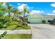Exterior shot of single-Gathering home with two-car garage, landscaped front yard, and sidewalks at 11466 Captiva Kay Dr, Riverview, FL 33569
