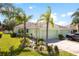 Charming one-story home with attached garage, well-maintained lawn and landscape with palm trees at 11466 Captiva Kay Dr, Riverview, FL 33569