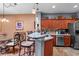 Stylish kitchen features stainless steel appliances, wooden cabinets, tile backsplash, and quartz countertops at 11466 Captiva Kay Dr, Riverview, FL 33569